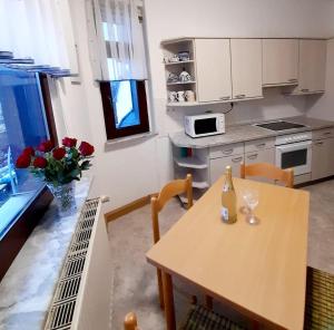 a kitchen with a wooden table and a table and chairs at Großzügige, komfortable Wohnung in Burgstaedt +8 photos