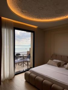 a bedroom with a bed and a view of the ocean at Seamare Studio & Apartaments in Vlorë