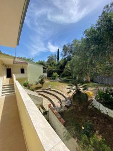 a view of a garden from the balcony of a house at Studio Pavlos in Dassia