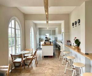 a kitchen and dining room with tables and chairs at Holm Corfu in Gouvia