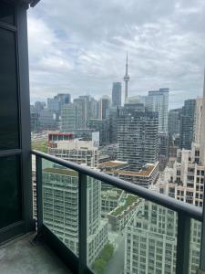 a view of a city skyline from a balcony at Downtown Toronto Suite By The Water in Toronto