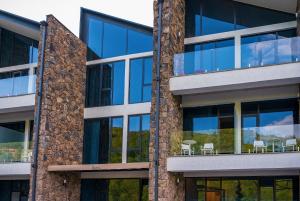 an office building with blue glass windows at Dilijan Inn Hotel and Restaurant in Dilijan