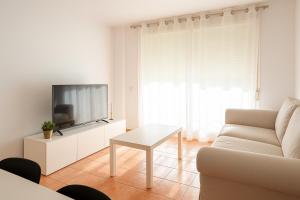 a living room with a couch and a tv at Bellamar tonwhouse in Alcalá de Chivert