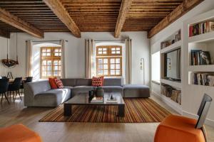 a living room with a couch and a table at le prieuré in Vals-les-Bains