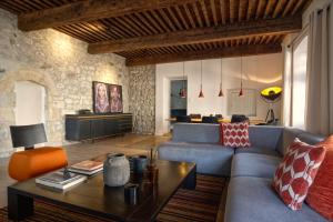 a living room with a couch and a table at le prieuré in Vals-les-Bains
