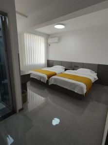 Postel nebo postele na pokoji v ubytování Little Mango Inn