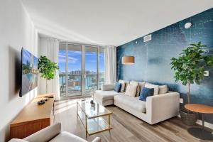 a living room with a couch and a table at Beachwalk Resort in Hallandale Beach