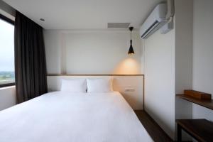 Ein Bett oder Betten in einem Zimmer der Unterkunft Shanmian Unmanned Hotel
