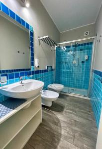 a bathroom with two toilets and a sink and a shower at La Locanda di Piazza in Santa Teresa Gallura +50 photos