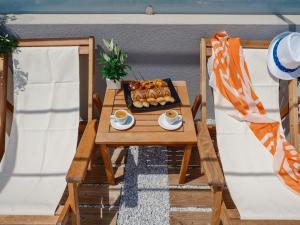 a table with a tray of bread and cups of coffee at ELiXiR 2 Luxury apartments in Agios Nikolaos