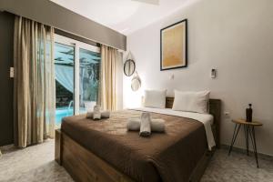 a bedroom with a bed with two towels on it at Bella Terra Villa Filerimos in Rhodes Town +37 photos