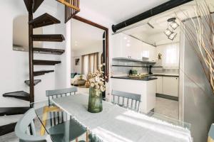 a kitchen and dining room with a table and chairs at Bella Terra Villa Filerimos in Rhodes Town