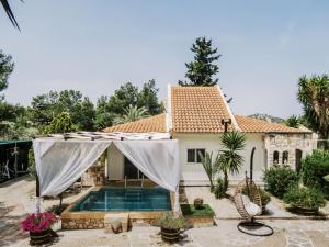 a villa with a swimming pool and a house at Bella Terra Villa Filerimos in Rhodes Town
