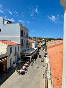 a view of a city street with tables and chairs at La Locanda di Piazza in Santa Teresa Gallura