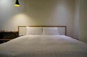 Ein Bett oder Betten in einem Zimmer der Unterkunft Shanmian Unmanned Hotel