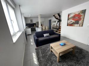 a living room with a couch and a coffee table at Appart 2 à croix in Croix