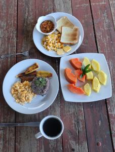 three plates of food on a wooden table at Granja los Campesinos in Monteverde Costa Rica