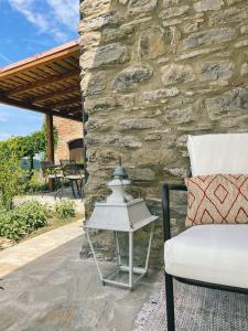 a patio with a white chair and a table at Ca' di Nieri The Saints' Lodge in Monte Santa Maria Tiberina +104 photos