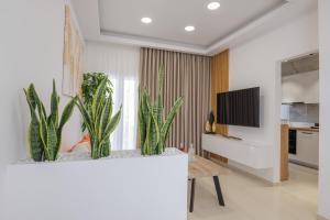 a living room with a table and some plants at ELiXiR 3 Luxury apartments in Agios Nikolaos