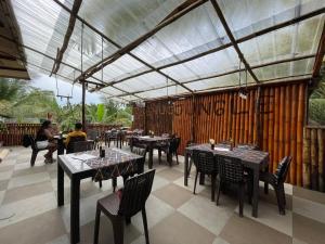 a restaurant with tables and chairs and people sitting at tables at Jungle restobar bed in Esperanza