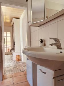 a bathroom with a sink and a mirror at Ferienwohnung Dreiflüsse in Hannoversch Münden +118 photos