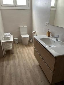 a bathroom with a sink and a toilet and a mirror at Casa Kiros in Cangas de Morrazo +17 photos