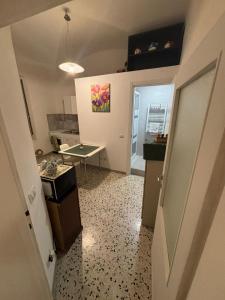 a room with a hallway with a table and a door at Tra i Vicoli Accommodation in Tivoli