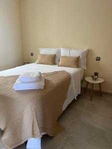 a bedroom with a large bed with towels on it at Cala Serena in Los Alcázares