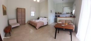 a bedroom with a bed and a table in a room at Studio Sykea SgS in Xylokastro