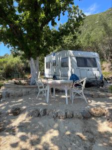 a table and two chairs in front of a trailer at TerraOliva&herbs in Vátos +94 photos