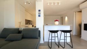 a living room with a couch and two bar stools at Val Mar in Novi Vinodolski