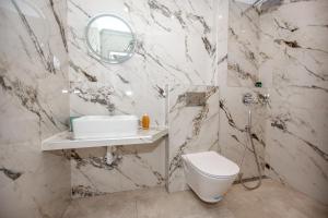 a bathroom with a toilet and a sink and a mirror at House Kohili in Nea Vrasna +37 photos
