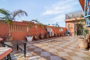 an outdoor patio with potted plants on a building at Marrakech apartment with city and Atlas Mountains view in Marrakech
