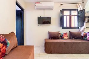 a living room with a couch and a tv at Marrakech apartment with city and Atlas Mountains view in Marrakech