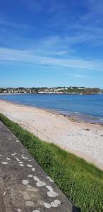 a beach with a body of water and the ocean at Nockys nook in Filey
