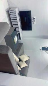 a living room with a couch and a tv at مسك 3 Musk in Al Madinah