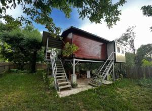 a tree house with stairs leading up to it at Kucica obala in Železnička Stanica Zeta