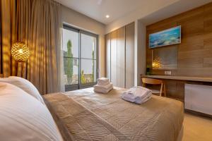 a bedroom with a bed with towels on it at Casa Tierra - Villa I in Kos Town