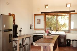 a kitchen with a refrigerator and a stove top oven at Casa de playa El Cortijo in El Puertecito