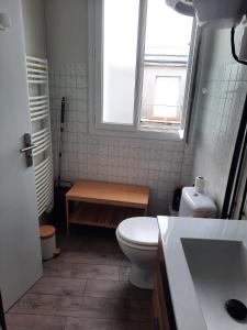 a bathroom with a toilet and a sink and a window at Rent studio 25 m2 city center, Brest in Brest