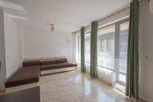 a living room with a couch and a large window at Sea Garden Marina 3 in Varna City