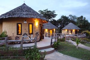 a house with a wooden walkway in front of it at Mari Pai Resort in Pai