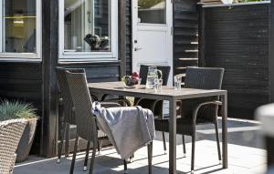 a wooden table and chairs on a patio at Pet Friendly Home In Hemmet With Wifi in Hemmet +10 photos