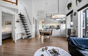 a living room with a table and a kitchen at Pet Friendly Home In Hemmet With Wifi in Hemmet