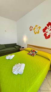 Ένα ή περισσότερα κρεβάτια σε δωμάτιο στο Ibisco Hotel