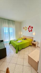 Ένα ή περισσότερα κρεβάτια σε δωμάτιο στο Ibisco Hotel