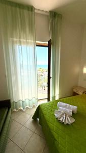 Ένα ή περισσότερα κρεβάτια σε δωμάτιο στο Ibisco Hotel