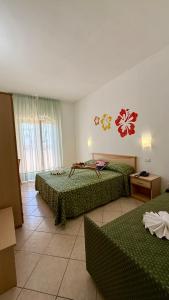 Ένα ή περισσότερα κρεβάτια σε δωμάτιο στο Ibisco Hotel