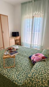 Ένα ή περισσότερα κρεβάτια σε δωμάτιο στο Ibisco Hotel