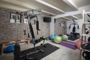 a gym with exercise equipment in a brick wall at Heritage Villa Lilly in Krnica